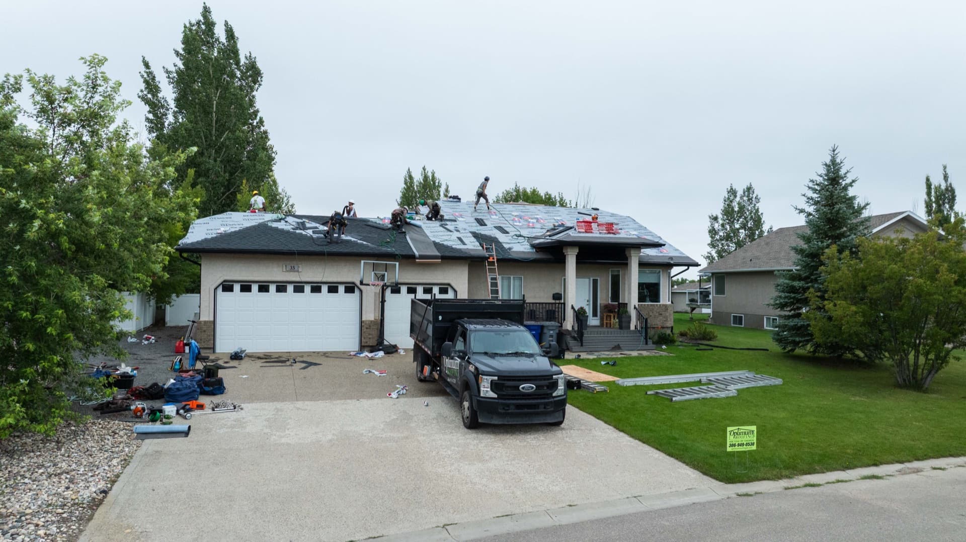 Lumsden reshingle with Optimum Roofing truck