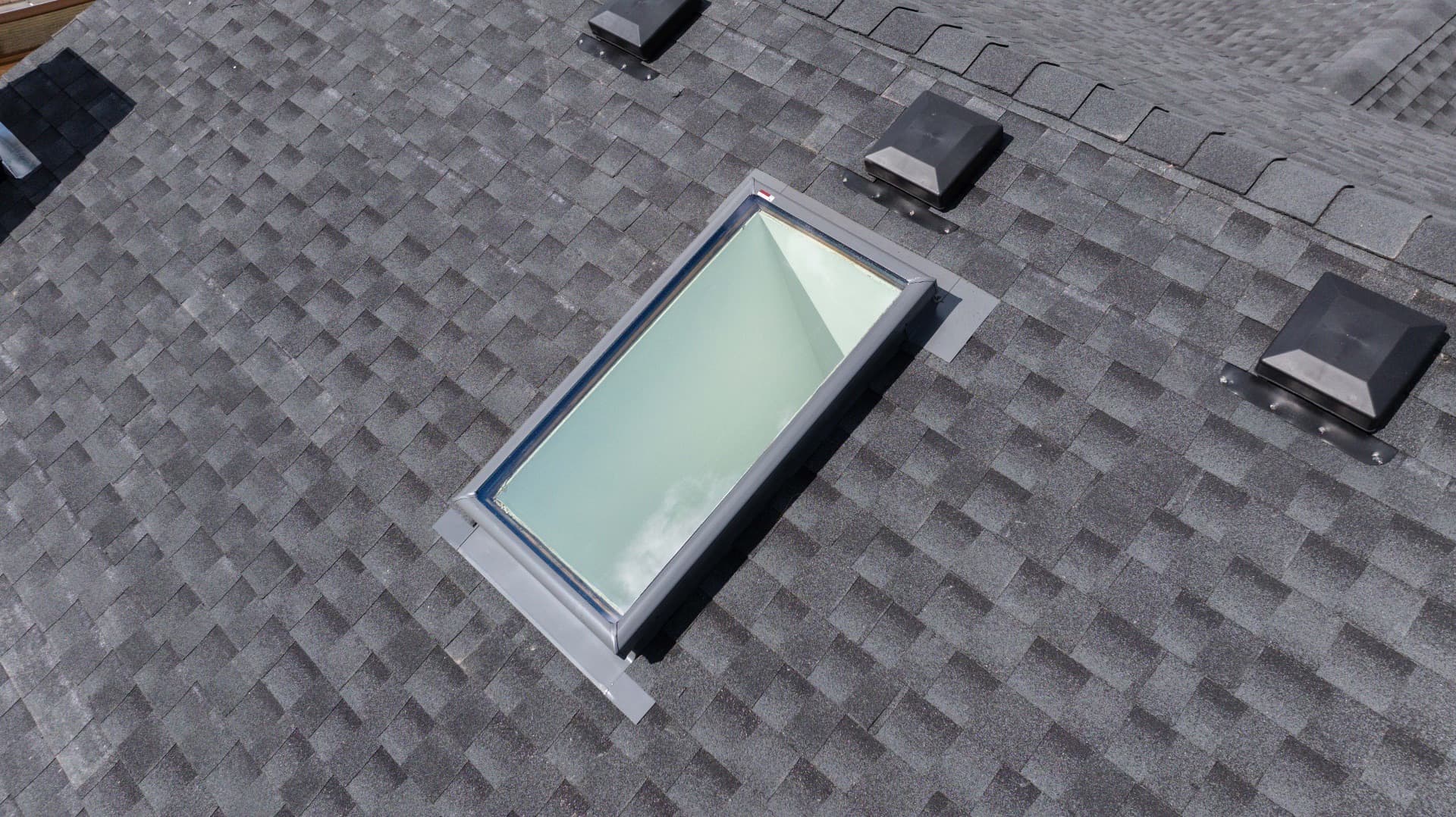 Optimum Roofing team installing skylight in Regina