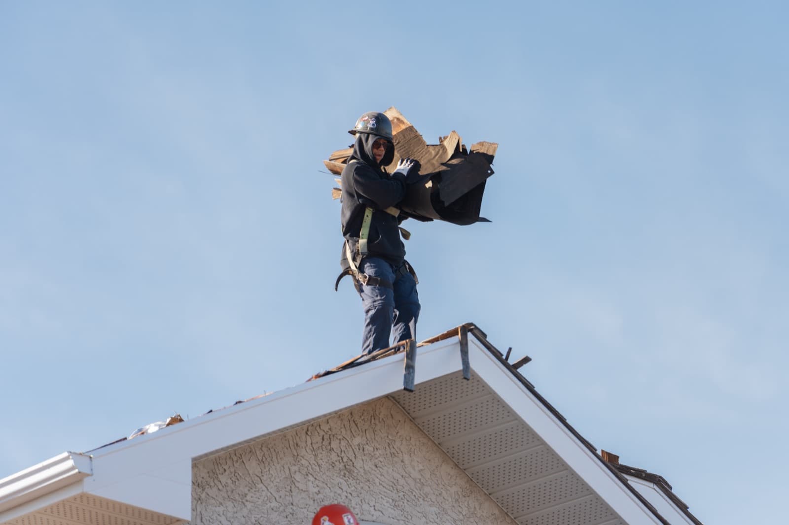 Optimum Roofing crew on a Regina shingle roof